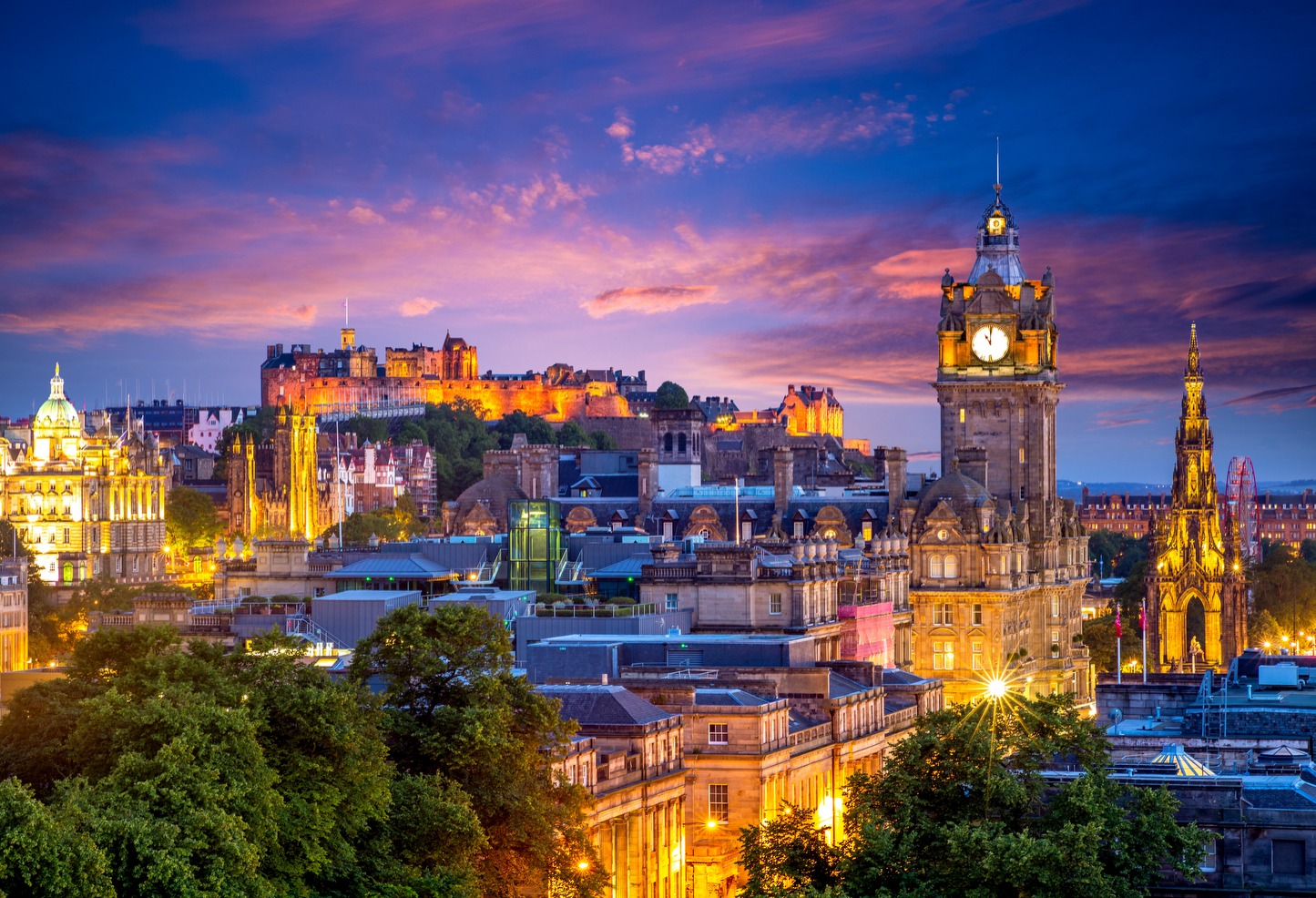 Edinburgh skyline at dusk with the castle and Balmoral clock tower