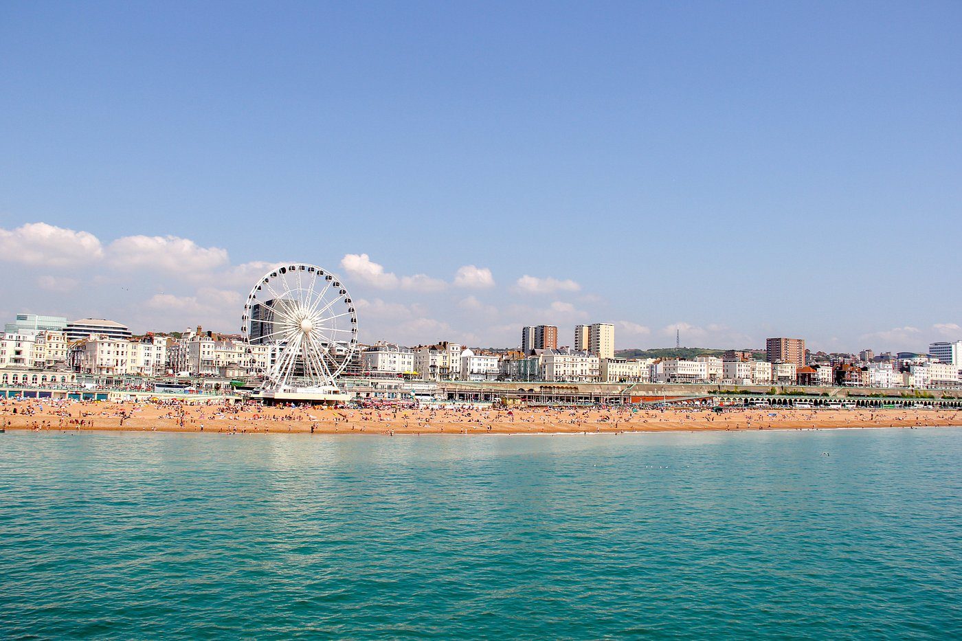 Brighton beach and the Brighton Wheel seen from the sea on a sunny day