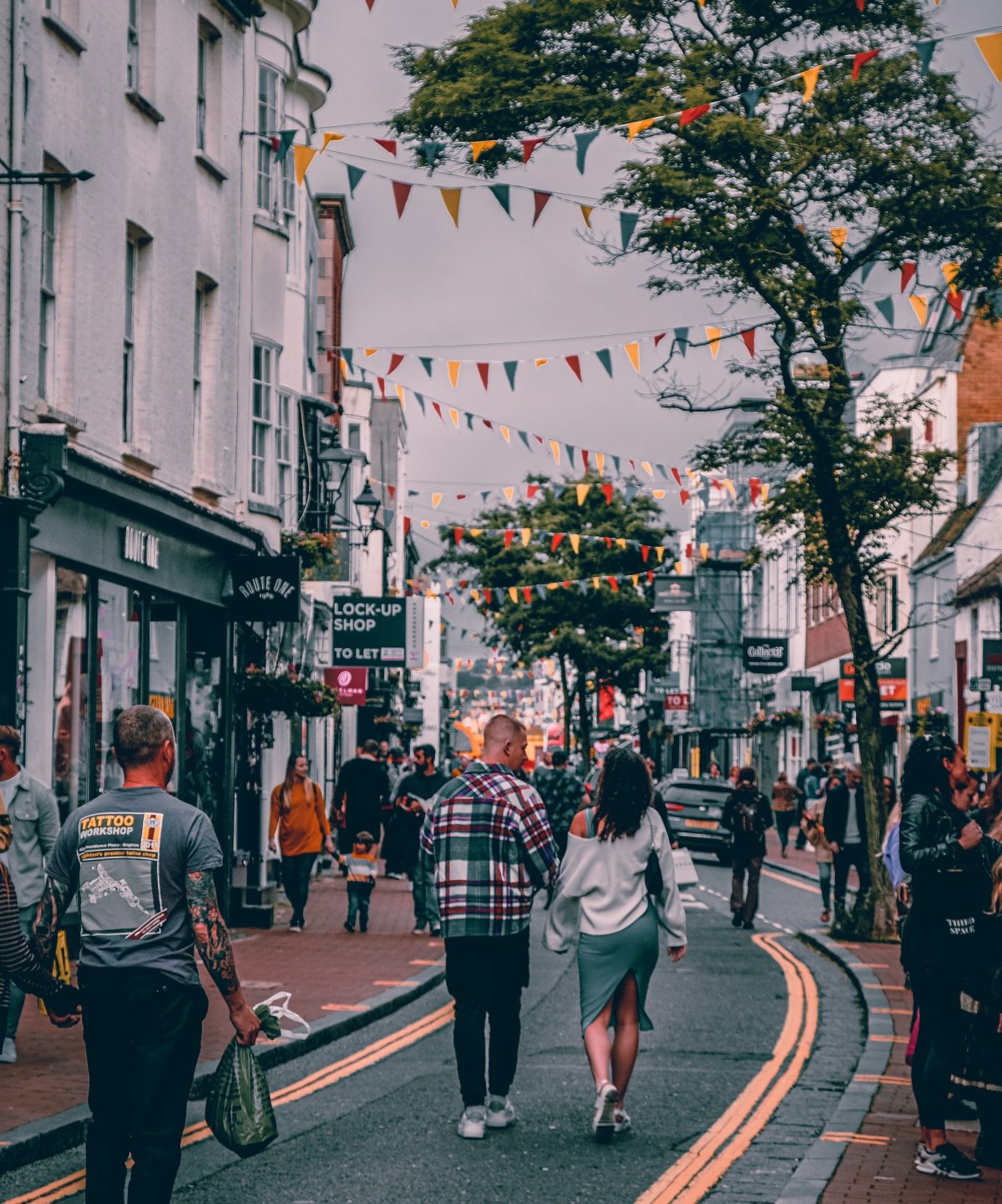 Shoppers walking down a bunting-decked street in Brighton's North Laine