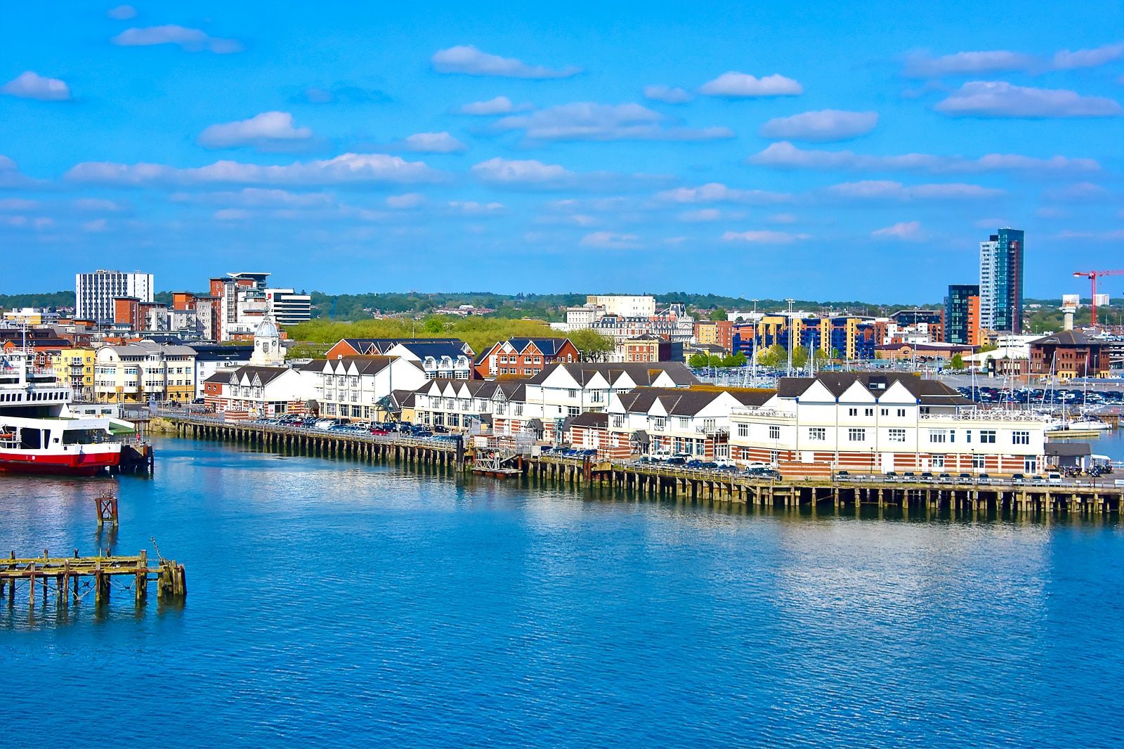 Southampton waterfront with the Red Jet ferry and city skyline under a blue sky