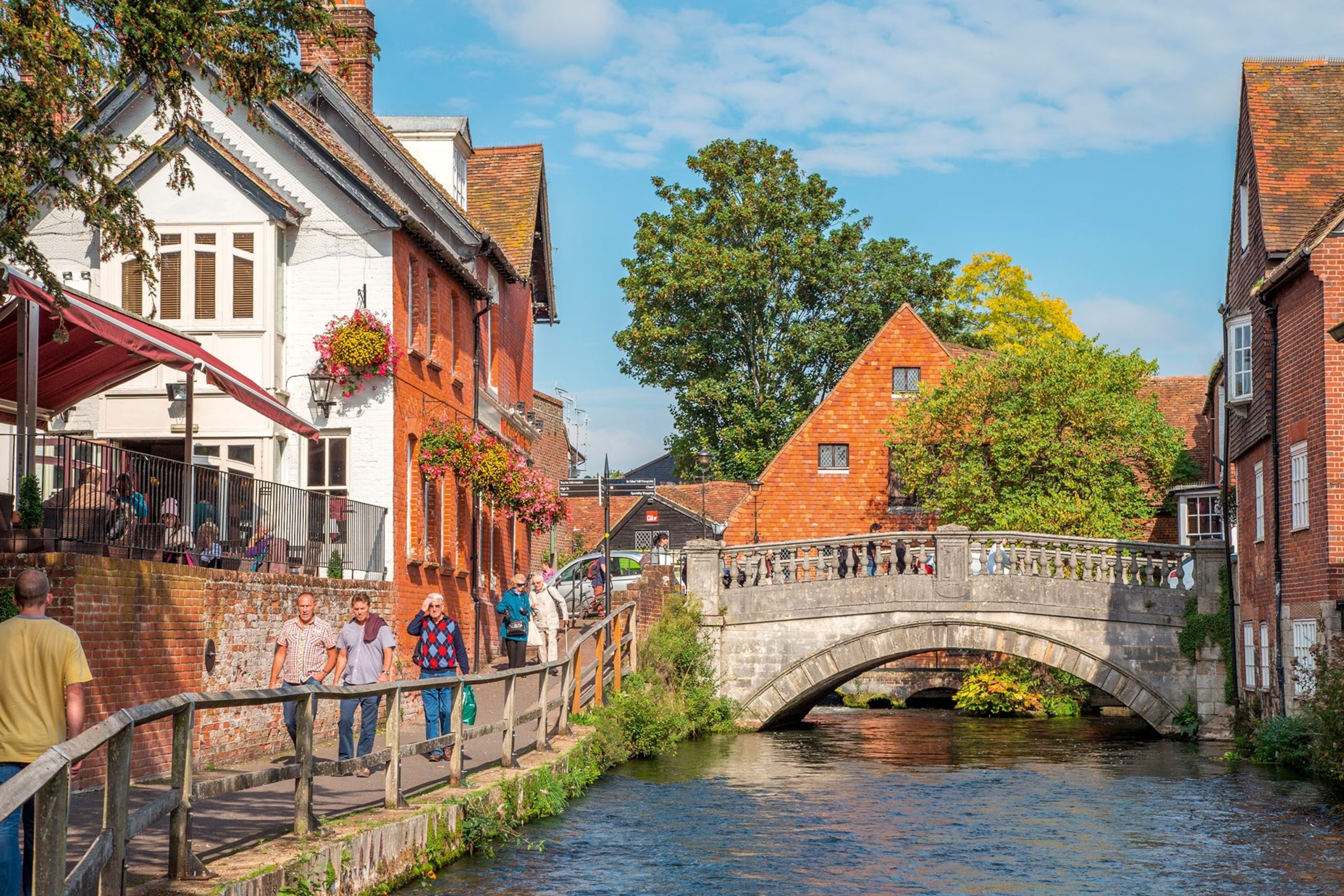 The River Itchen and City Bridge in Winchester with a riverside pub and stone bridge